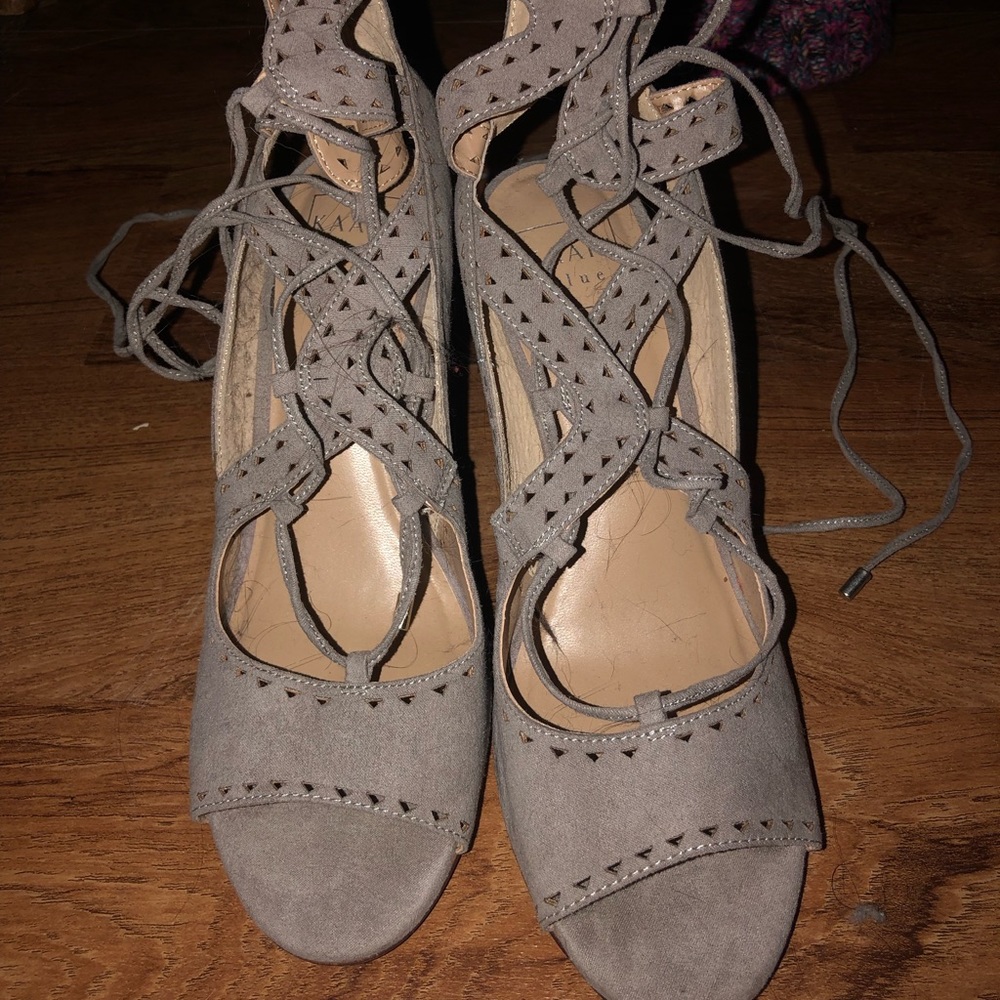 Tan high heel strap up shoes